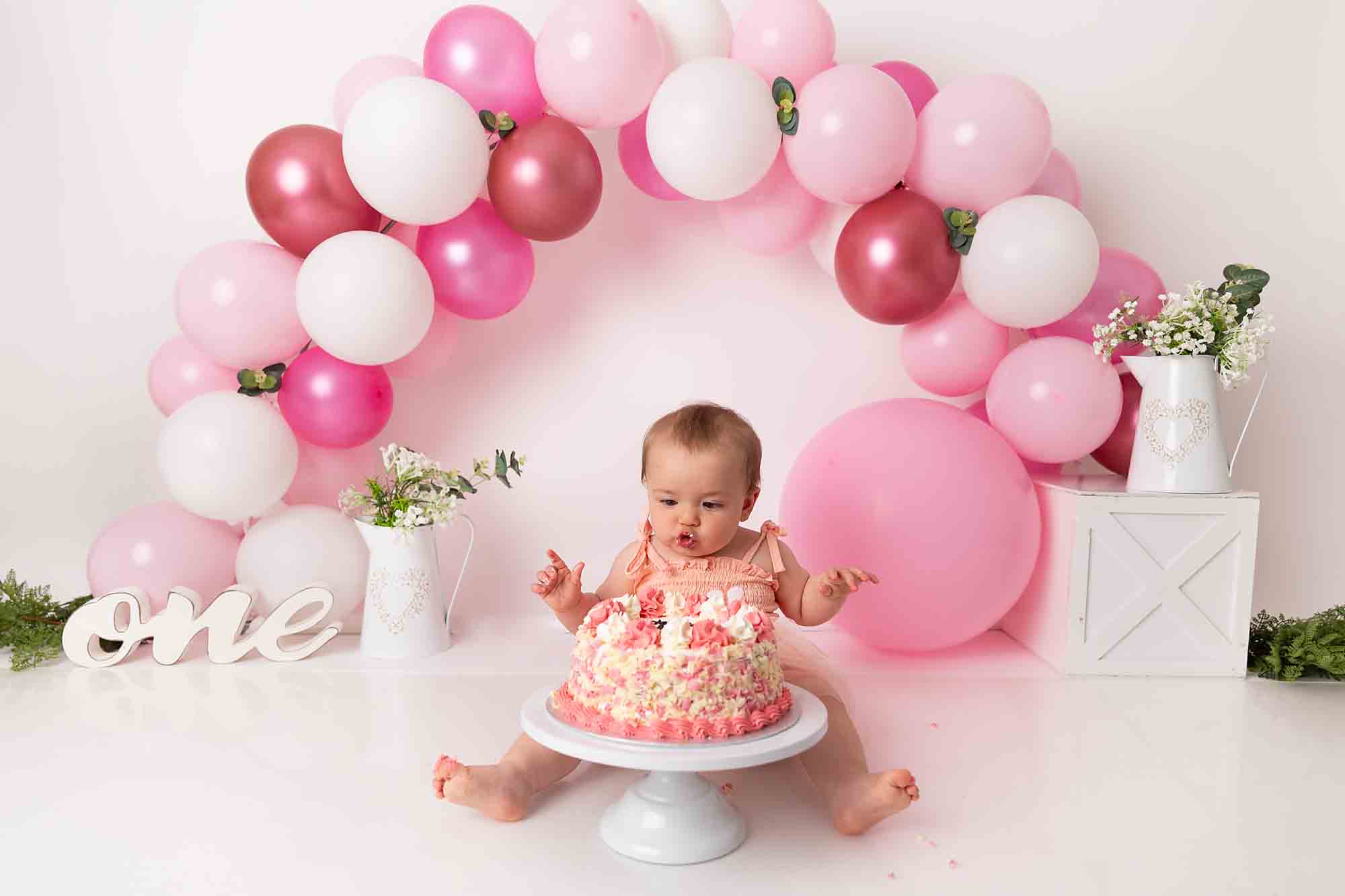 pink balloon arch cake smash