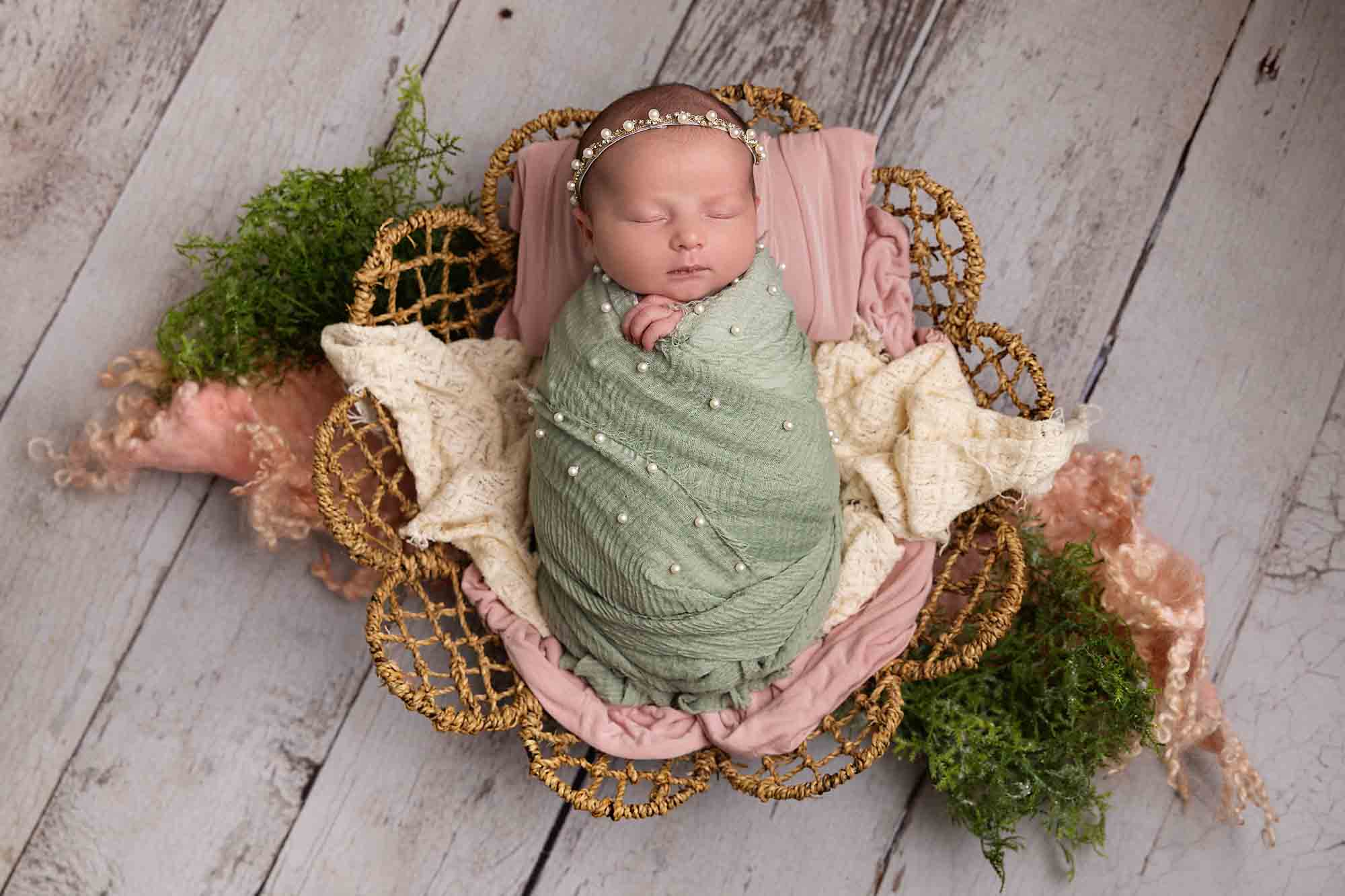 baby with sage green and pink