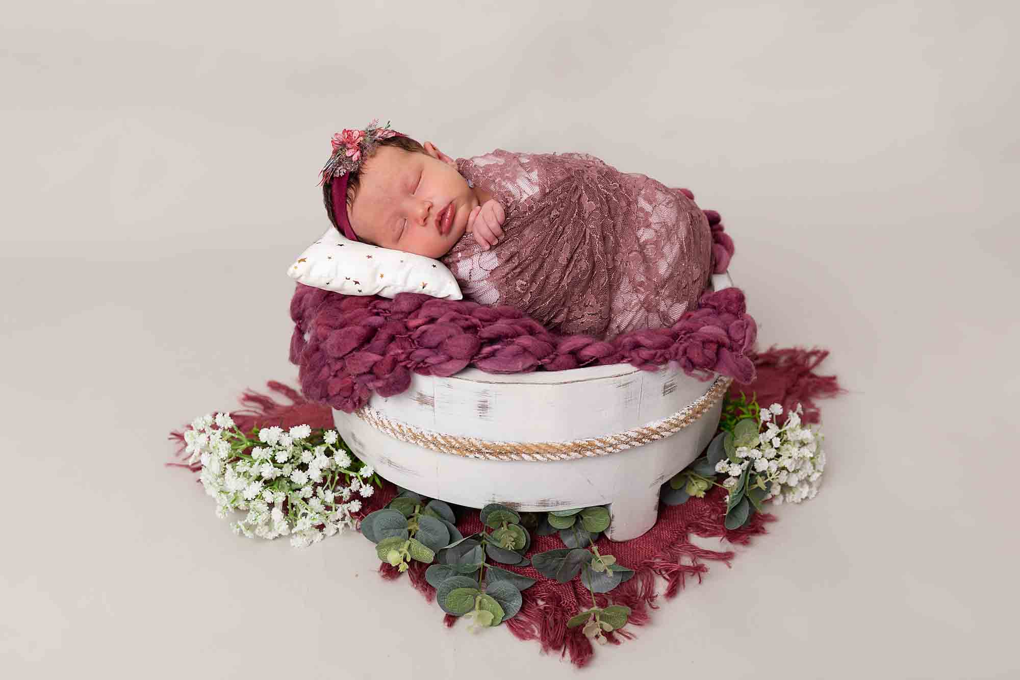 baby in raspberry pink basket